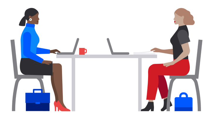 Computer users at table